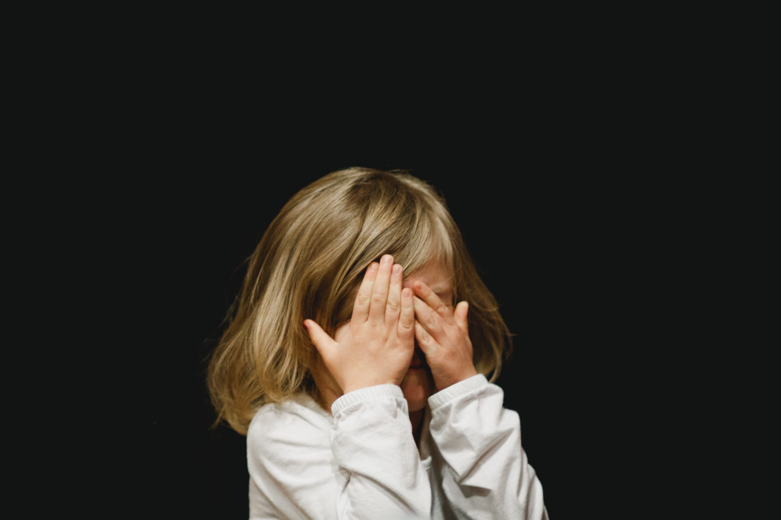 child covering their eyes