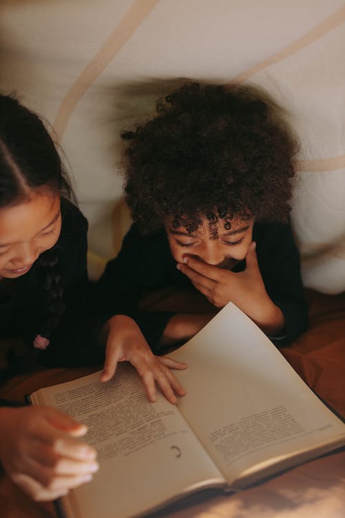 two children reading a book