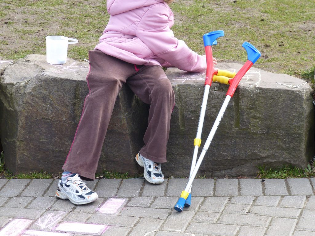 Child with a disability playing with chalk.