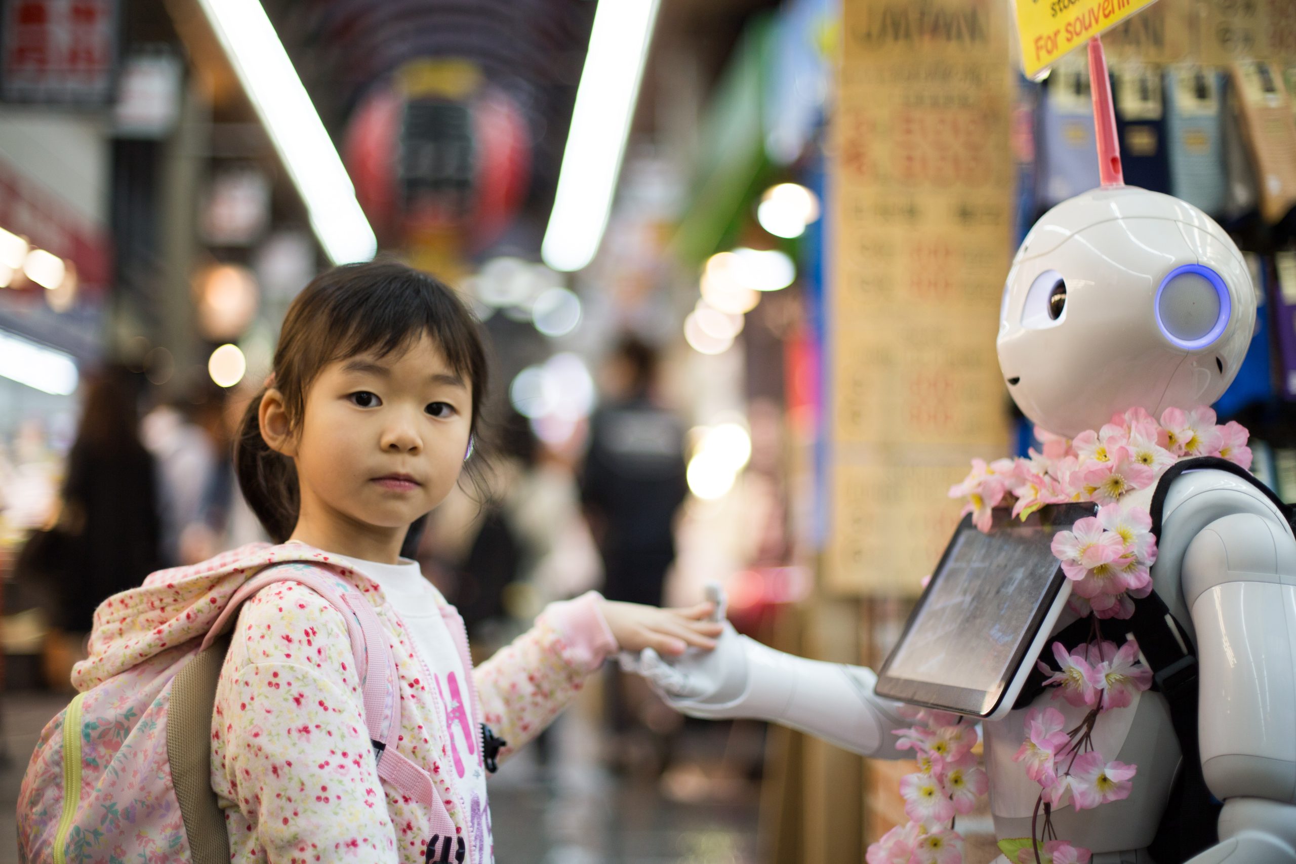 Child making friends with a robot