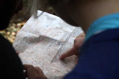 A person pointing their finger at the map