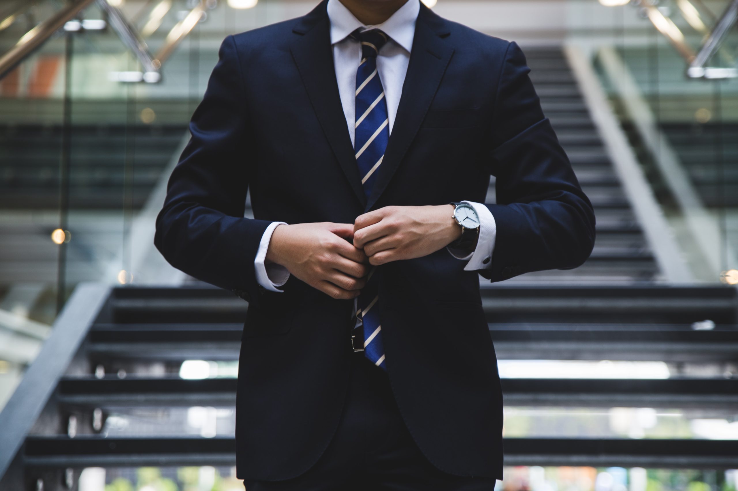 person with a nice suit standing near the stairs