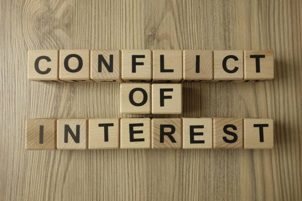 conflict of interest text from wooden blocks on desk