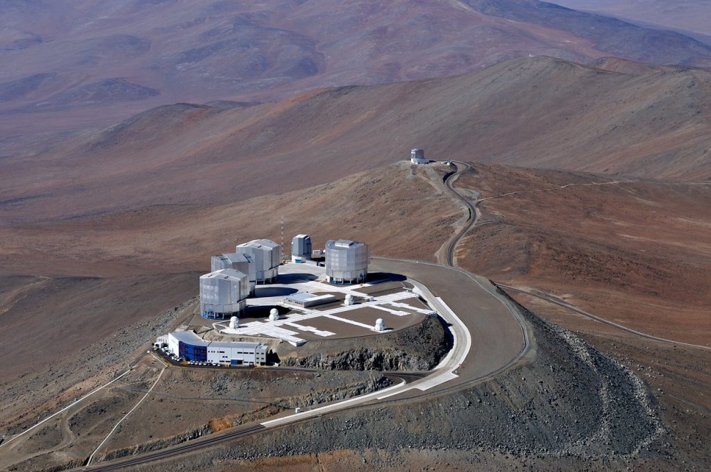 An aerial view of the Paranal Observatory in Chile shows the four Unit Telescopes of the Very Large Telescope and the VLT Survey Telescope.