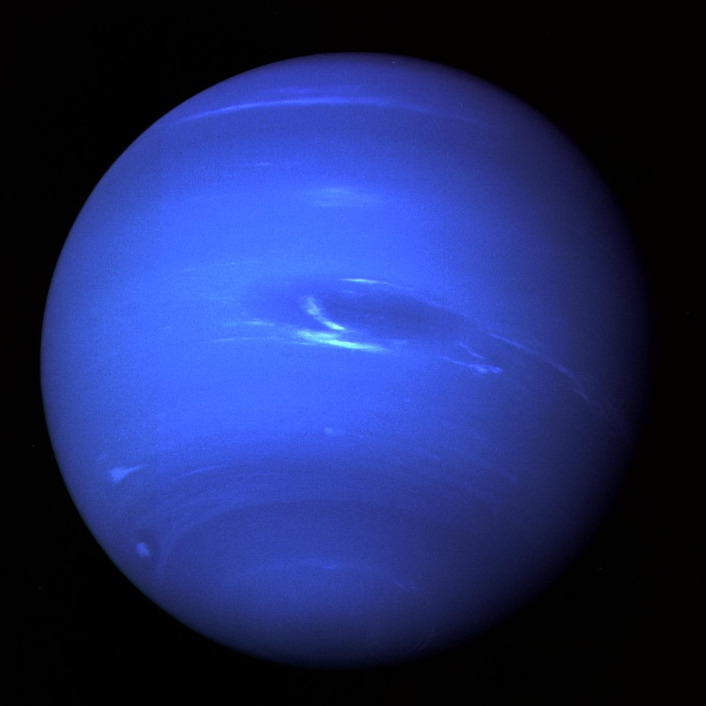 Blue Neptune. The blue sphere of Uranus is nearly featureless, save for dark bands near the poles, a few scattered white clouds, and a dark spot (near the centre in this image) similar to the Great Red Spot on Jupiter.