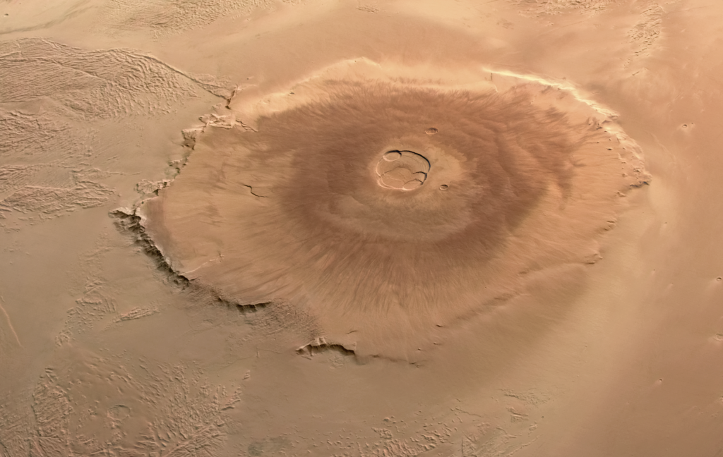 Computer-generated image of Olympus Mons. This huge, dome-shaped volcano rises out of the surrounding plain. At the top and very near the centre of the dome is the large caldera.