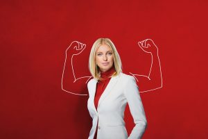 Employee Standing with Powerful Arms Drawn on Wall Behind