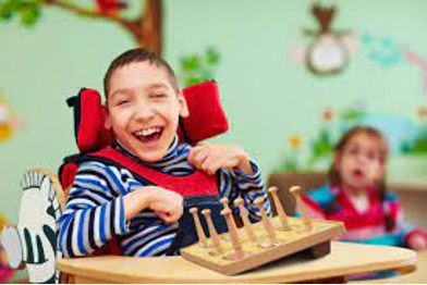 A young boy with cerebral palsy with sitting in a wheelchair.