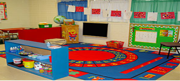 A large blue and red carpet is at the centre of a children's classroom.