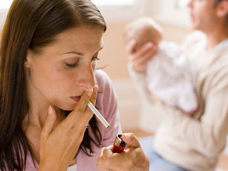 A woman holds a cigarette to her lips with a lighter at the end of the cigarette, ready to light it.