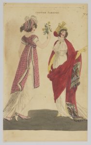 A hand-coloured etching of a fashion plate. the image focuses on two white female figures placed equally on the left and right of the image. The figure on the left has her back turned to the viewer and is wearing a pink and white dress. The dress has a long white skirt and short white sleeves. The rest of the dress is pink, with black trim and is patterned with black dots. This figure is also wearing a hat of a similar design that is accented with a number of white feathers. She is holding some yellow flowers in her right hand and is extending this arm to the figure on the right. The rightmost figure's body is facing towards the viewer, with her gaze looking off to the right of the image. She is wearing a long white dress, with a long red cape, accented with a multicoloured fabric print, that starts at the back of her neck and drapes around her body and over her left arm which is pointing to the right. She is wearing long yellow gloves and a hat that matches the colour of the cape and gloves.