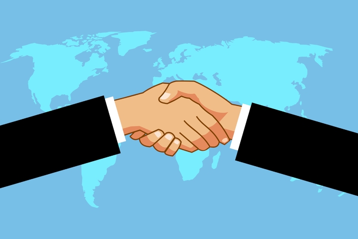 drawing of a handshake with the world map in the background