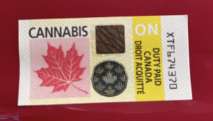 A seal with a drawing of a maple leaf, lines, and holographic elements displayed on all cannabis products sold in Ontario, Canada. It shows that duty has been paid, and has an unique code in the typeface similar to a bank transit numbers on a cheque.