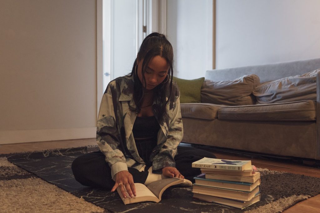 woman sitting on the floor reading