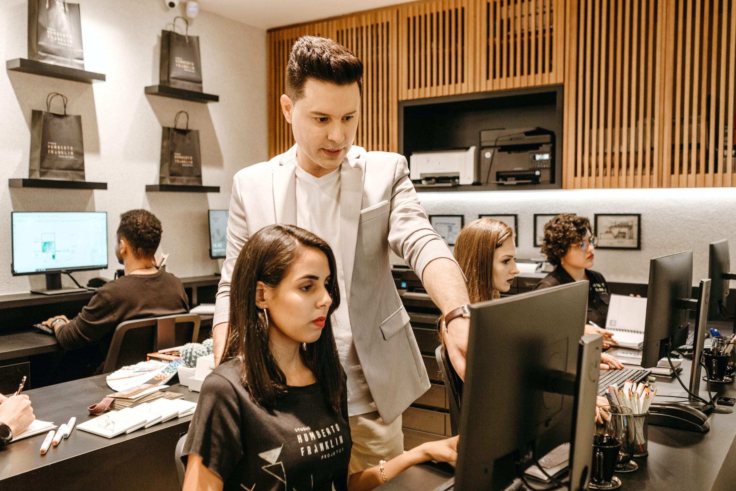 Manager showing employee something on the computer screen