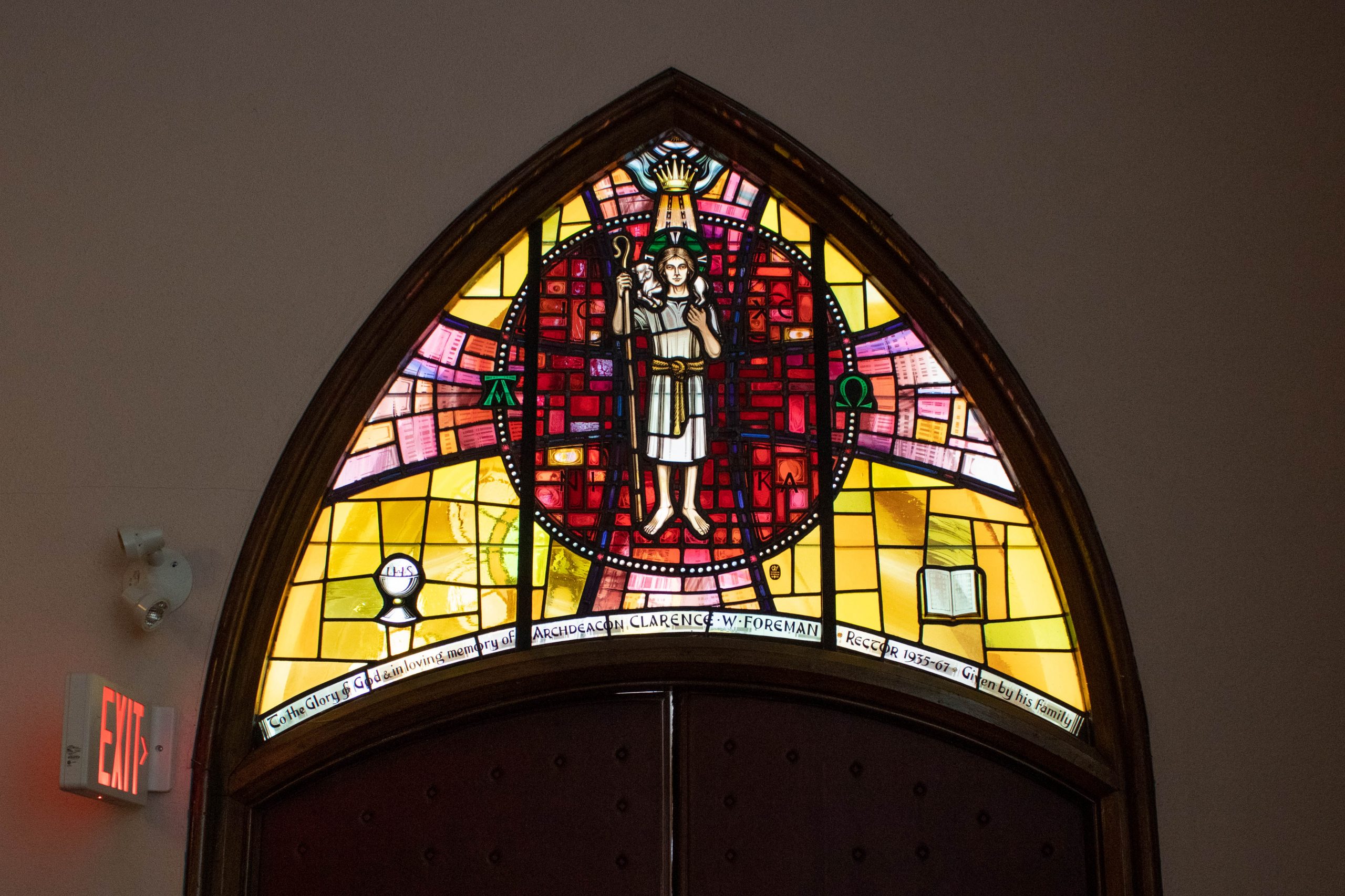 Stained Glass showing man carrying a sheep.