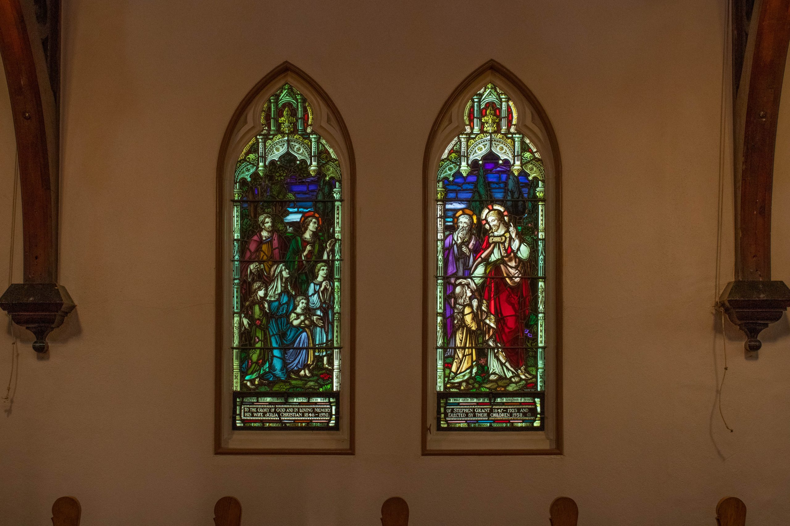 Two stained glass windows. Each with multiple figures
