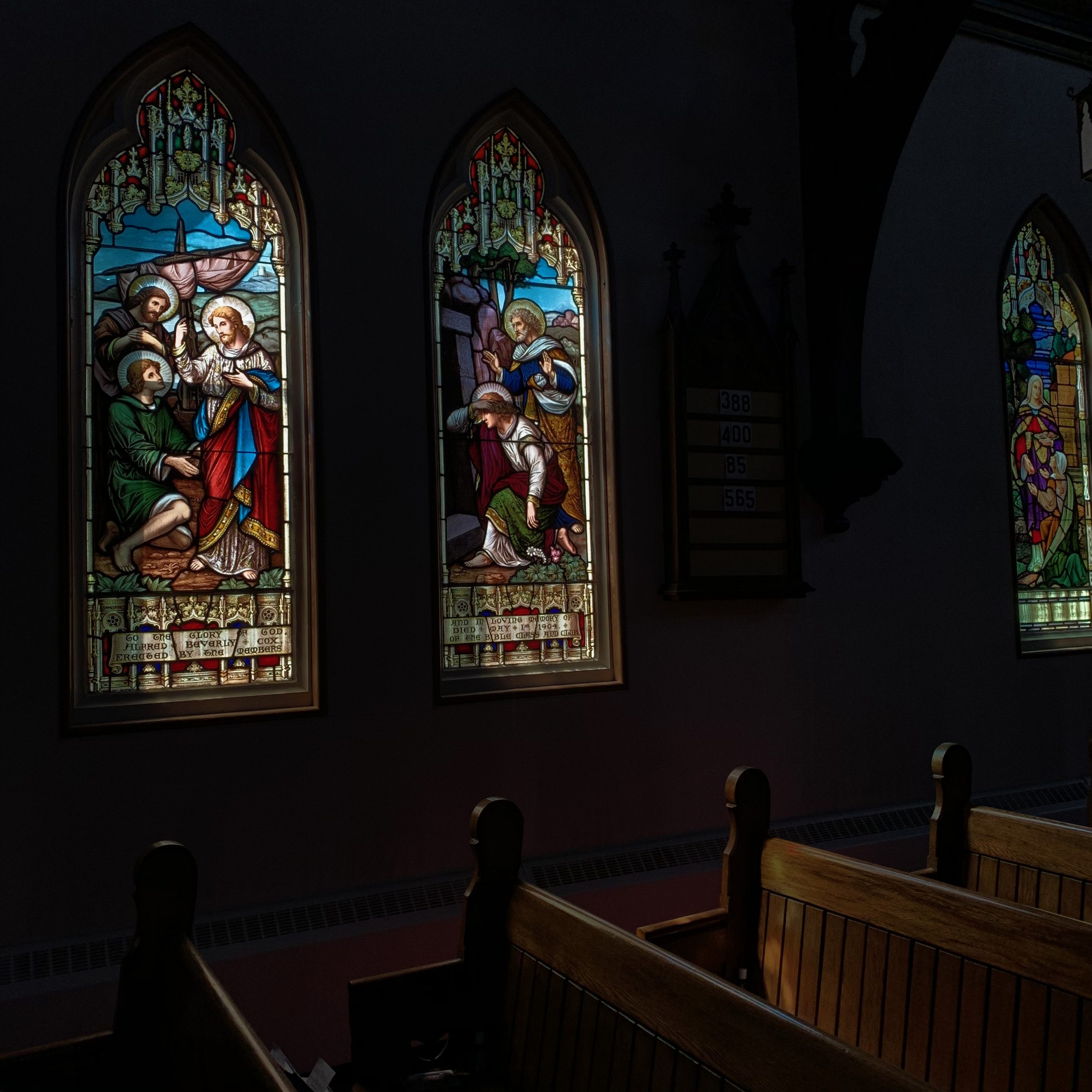 A nave showing multiple stained glass windows.