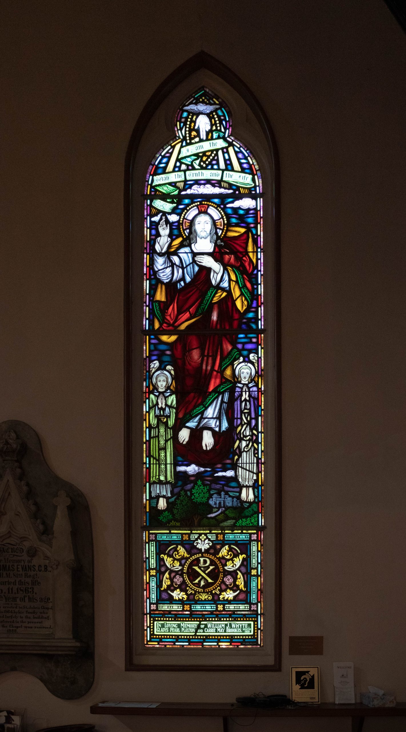 window showing man and angels