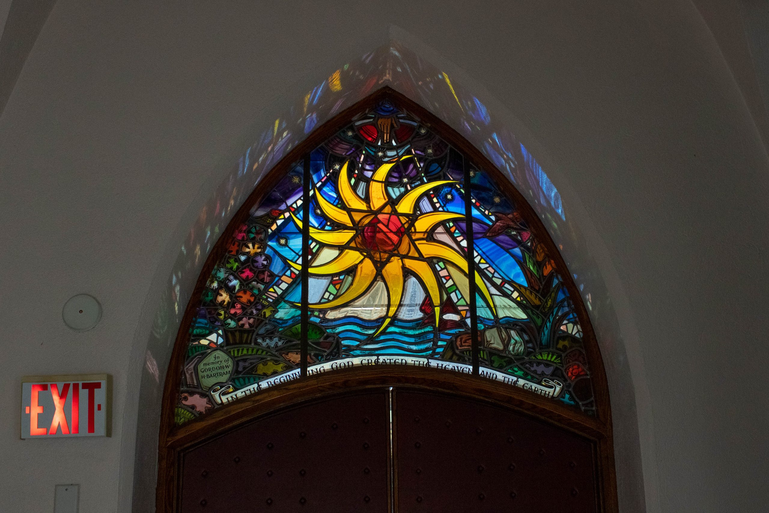 Stained glass window showing spiral sun.