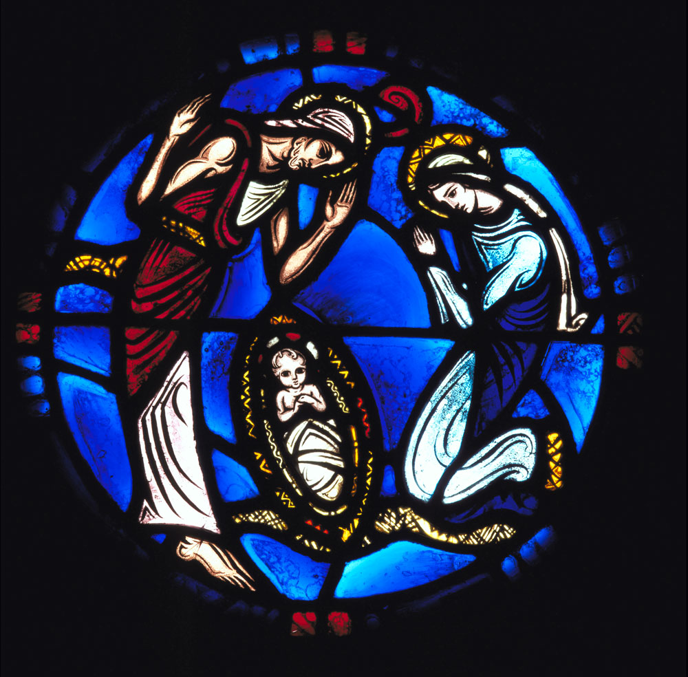 Circular stained glass window depicting a man, an infant, and a woman