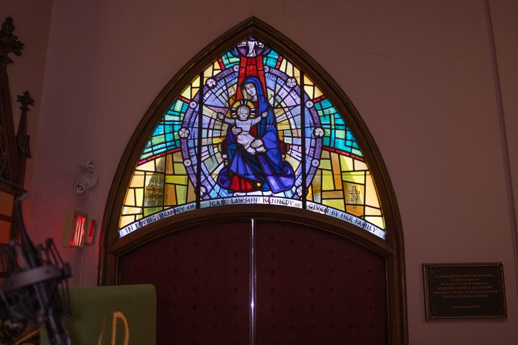 Transom stained glass window showing woman and child.