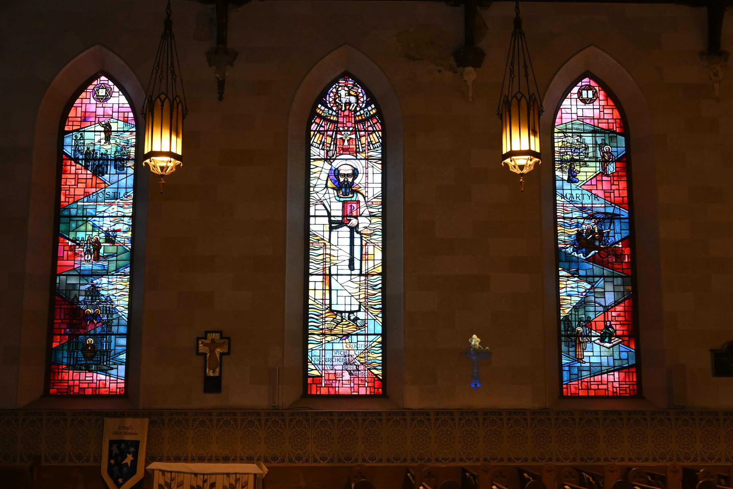 Three stained glass windows illustrating the life of St. Paul