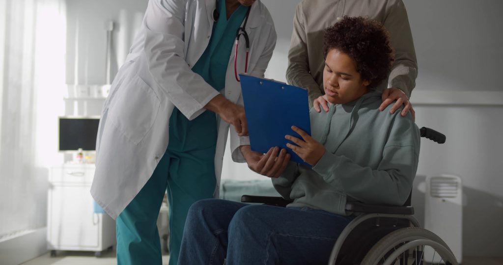 Image of medical staff review discharge notes with a simulated patient and caregiver