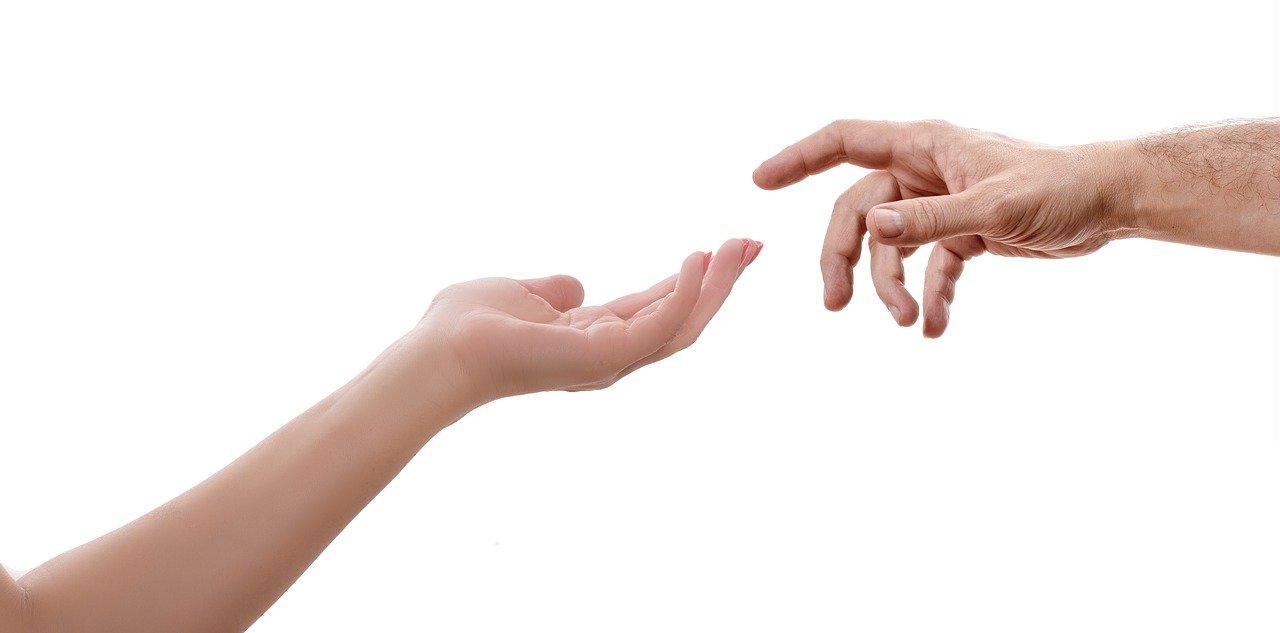 Two hands reaching out to each other