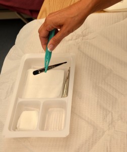 Arrange sterile items on field