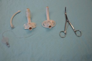 Left to right: obturator, cuffed tracheostomy tube, non-cuffed tracheostomy tube, tracheal dilators