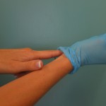 Insert finger under cuff of gloved hand