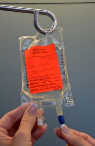 Remove sterile blue cap from IV bag