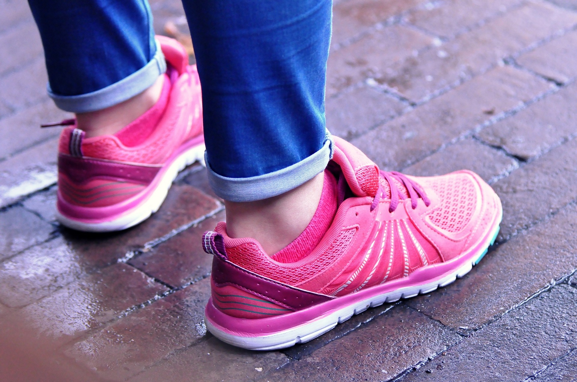 Feet wearing pink running shoes