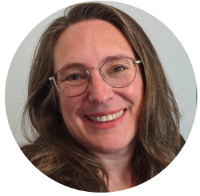Smiling woman with long brown hair and glasses