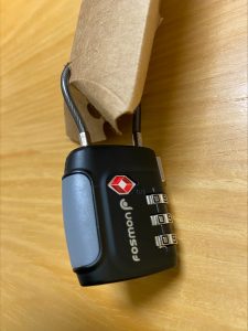 black three digit combination lock on a small package