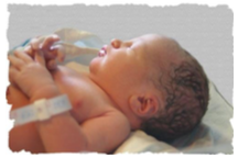 Newborn baby sleeping on their back and wearing a hospital bracelet