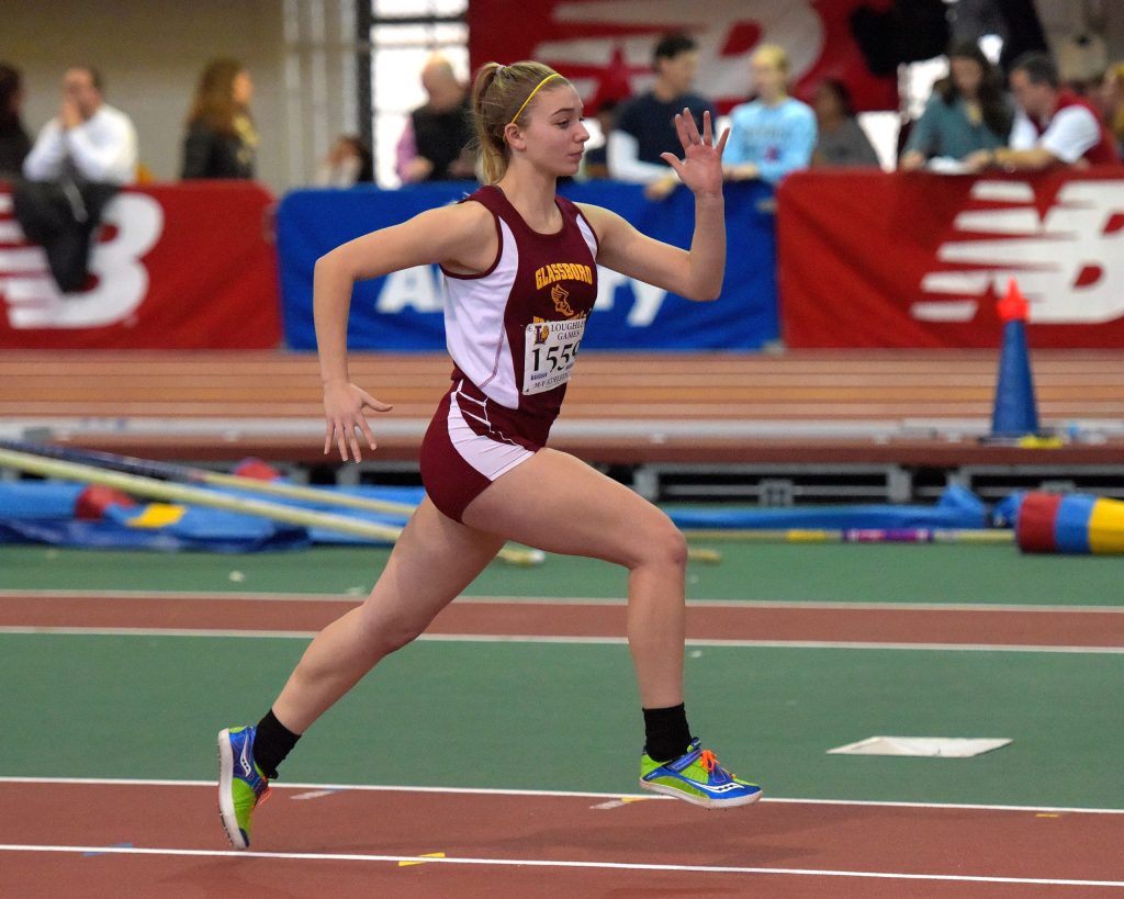 Women sprinting on an indoor track