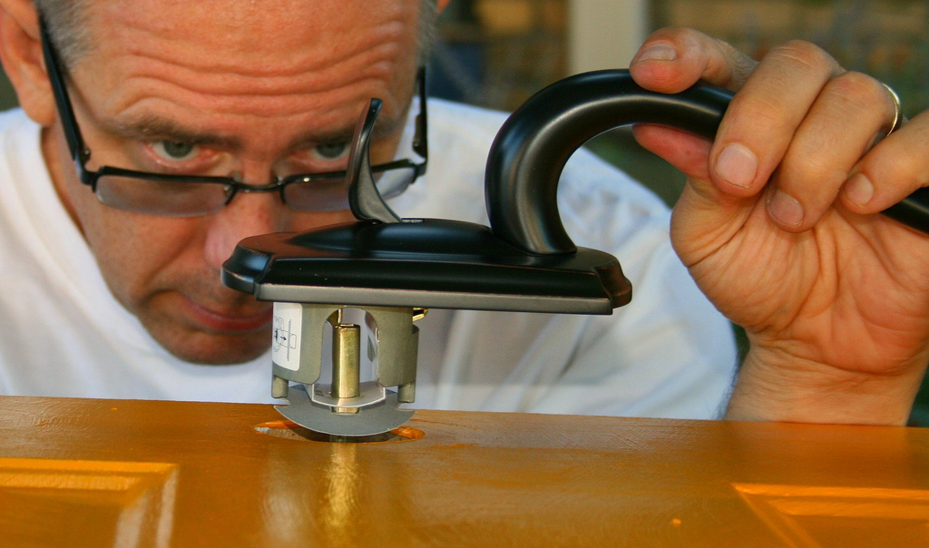 A man fixing a door knob