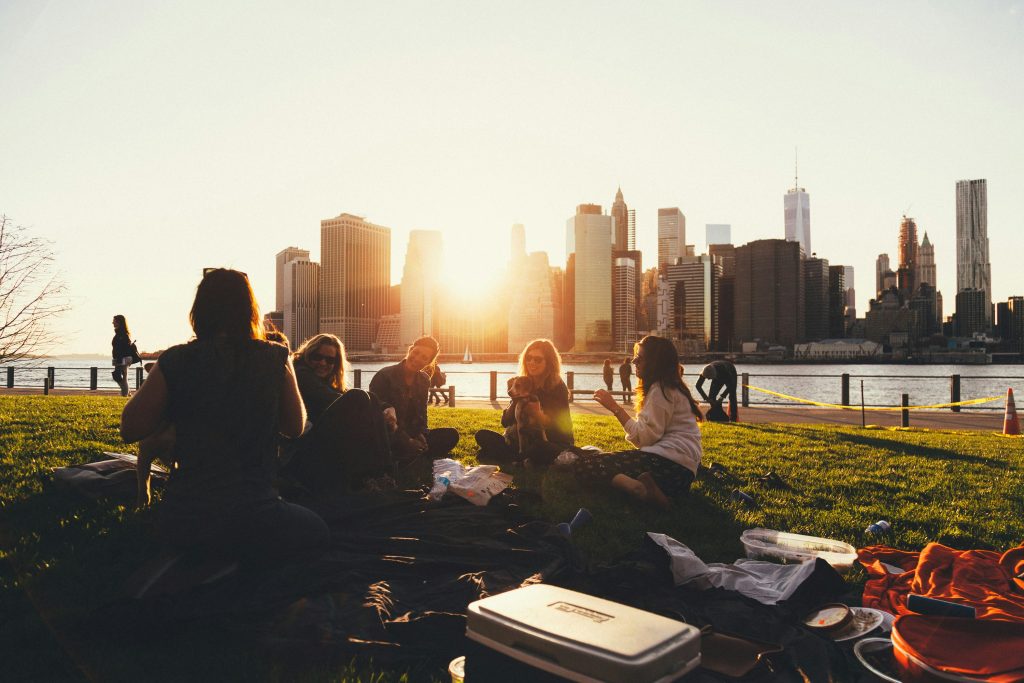 Image of a group of people sitting on a lawn conversing