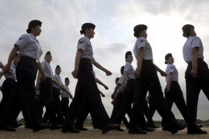 A group of women walk in straight lines perfectly in sync with one another.