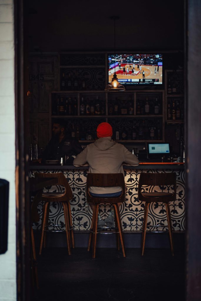 Person watching TV in a bar