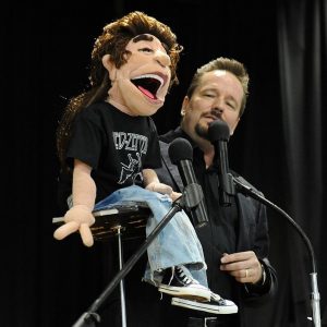 ventriloquist on stage with puppet
