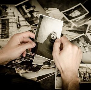 photo of a set hands holding a sepia photo