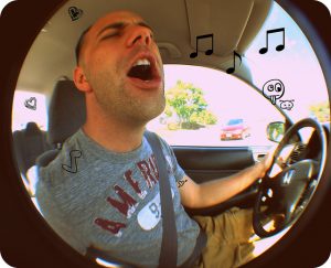 man singing while driving