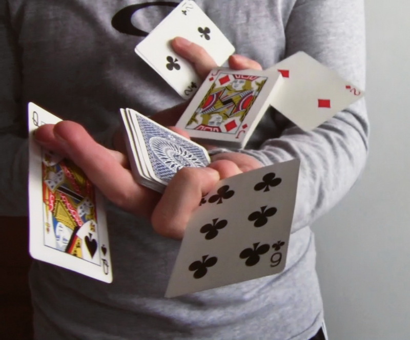 photo of a close up of a person holding multiple playing cards