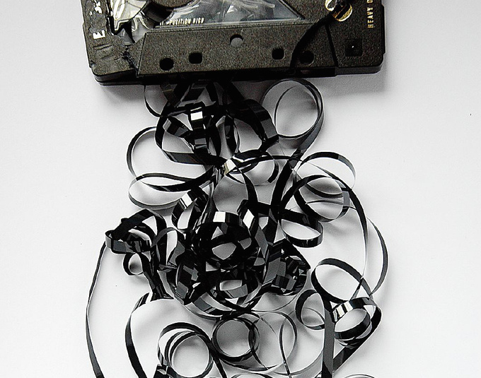 photo of broken cassette tape with tape pulled out of cassette