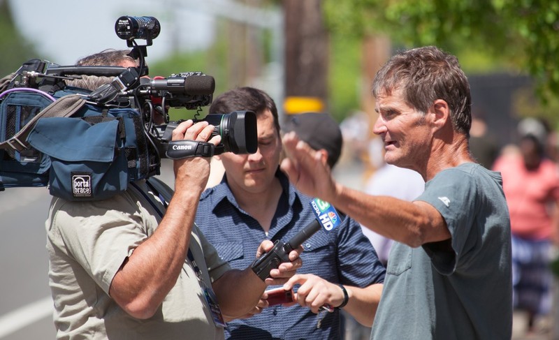 photo of film crew interviewing a man on a street