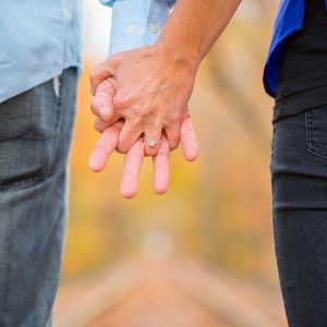 close up photo of two people holding hands