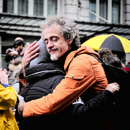 photo of two people hugging in the street